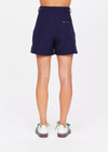 THE UPSIDE women's navy Mansi Wyatt Tailored Short is made from recycled fabric with moisture wicking properties. The long line shorts are fitted with front and back zip pockets for practicality. Designed for golf.