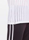 THE UPSIDE women's white Muse Wales Knit Tank Top is made from a organic cotton knit construction.The basketball tank shape features a ribbed neckline and armholes. Designed for light movement and recovery.