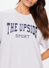 THE UPSIDE women's grey Harbor Sammi Tee is made from organic cotton. The oversized jersey is fitted with a rib neckline and navy logo on the front. Designed for all types of movement.