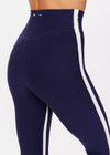 THE UPSIDE women's navy Hamptons 25 inch Midi Pant is made from recycled soft peached fabrication with a brushed handfeel and a breathable, quick drying effect. The high waisted pant has a V panel waistband and features colours of cream and white for an elevated look. Designed for yoga and pilates.