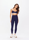 THE UPSIDE women's navy Hamptons 25 inch Midi Pant is made from recycled soft peached fabrication with a brushed handfeel and a breathable, quick drying effect. The high waisted pant has a V panel waistband and features colours of cream and white for an elevated look. Designed for yoga and pilates.