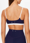 THE UPSIDE women's navy Hamptons Ballet Bra is made from recycled soft peached fabrication with a brushed handfeel and a breathable, quick drying effect. The low coverage ballet bra features elastic straps with adjusters. Designed for yoga and pilates.