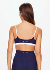 THE UPSIDE women's navy Hamptons Ballet Bra is made from recycled soft peached fabrication with a brushed handfeel and a breathable, quick drying effect. The low coverage ballet bra features elastic straps with adjusters. Designed for yoga and pilates.