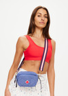 THE UPSIDE women's blue Pacific Voyage Crossbody Bag is made from recycled fabric. The mini quilted crossbody bag features adjustable and removable straps.