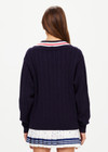THE UPSIDE women's navy Renshaw Josette V Neck Sweater is made from organic cotton. The fitted sweater features a V-neck neckline and cable knit detailing.