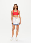 THE UPSIDE women's white star patterned Stellarium Valetta Mini Skirt is made from recycled fabric. The pleated mini skirt features built in shorts with pockets. Designed for tennis and pickleball.