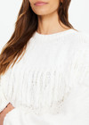THE UPSIDE women's natural Kansas Tassel Boo Knit Sweater is made from organic cotton. The relaxed crewneck sweatshirt features cable knit design. Designed for lifestyle wear.