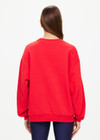 THE UPSIDE women's red Ranchero Saturn Crew Sweater is made from organic cotton. The oversized sweater features print western logo. Designed for lifestyle wear.
