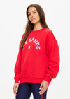 THE UPSIDE women's red Ranchero Saturn Crew Sweater is made from organic cotton. The oversized sweater features print western logo. Designed for lifestyle wear.
