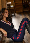 THE UPSIDE women's navy Oxford 25 inch Midi Pant is made from eco tech performance fabric. The gym leggings features red side stripes detailing. Designed for high impact workouts.