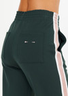 THE UPSIDE women's dark green Monte wide leg, high waisted trackpant features an elastic waistband, side stripes, and front and back pockets.