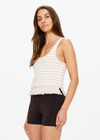 THE UPSIDE women's natural Canyon Freida Knit Fringe Top is made from organic cotton. The scoop neck top features knitted fringe. Designed for lifestyle wear.