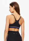 THE UPSIDE women's black Revolver Jade Racerback Bra is made from recycled rib. The supportive sports bra features removable cups. Designed for the gym and high impact exercise.