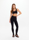 THE UPSIDE women's black Pegasus Farrow Split Pant is made from recycled peached. The mid rise pants features split flare hem. Designed for yoga and pilates.