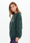 THE UPSIDE women's dark green Alumni Coolum Crew Neck Sweater is made from organic cotton and feature small side splits, front zip pocket and side pockets.