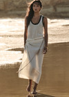 THE UPSIDE women's cream Beach Serenade Wrap Sarong is made from cotton. The beach sarong skirt features vegan leather braided belt. Designed for layering and travel.