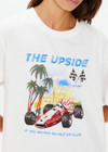 THE UPSIDE women's cream organic cotton Raceway Sammi Tee is designed for an oversized fit with printed raceway graphics on the front.