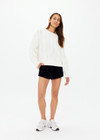 THE UPSIDE women’s off white Espada Talia cable knit sweater is made in a relaxed fit from chunky organic cotton and features a crew neck and ribbed neckline, cuff and hem.