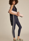 THE UPSIDE women's navy recycled peached Daytona 25 inch Legging is designed for a high-rise supportive fit and features contrast cream binds. Perfect for yoga.