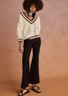 THE UPSIDE women's white organic cotton Josette V Neck Knit Sweater features a striped cable neckline in orange and navy. Made for everyday leisure.
