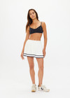 THE UPSIDE women's creme Cadiz Pleated Knit Skirt features an elasticated waistband with navy contrast knitted stripes. Perfect for tennis.