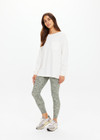 THE UPSIDE women's cream recycled cotton Soho Cara Long Sleeve Top is designed for a relaxed fit and features a ribbed neck and cuffs and a patch pocket at front. Made for everyday leisure.