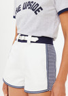 THE UPSIDE women's white organic cotton Racer Short features a navy waistband with a built-in belt detail and back welt pockets. Made for everyday leisure.
