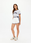 THE UPSIDE women's white organic cotton Racer Short features a navy waistband with a built-in belt detail and back welt pockets. Made for everyday leisure.