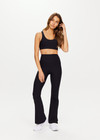 THE UPSIDE women's black Peached Florence Flare is a high-rise full length flare pant with V waistband and a printed arrow logo on back waistband.