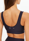 THE UPSIDE women's black Oxford Harley Scoop Bra offers a supportive & comfortable fit made from eco tech performance fabric and features removable cups and contrast white stripes down sides. Made for high impact.