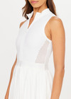 THE UPSIDE women's white Slam Pleated Tennis Dress features a quarter zip opening with mock neck, a pleated light-weight skirt with built-in inner short with pockets. Made for tennis.