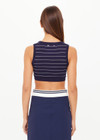 THE UPSIDE women’s Stripe Astra Solange Knit Crop Top offers a soft, comfortable fit with a navy-ribbed scoop neckline and elastic underbust. Perfect for travel or daily wear.