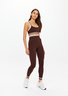 THE UPSIDE women's brown Form Seamless 25in Midi Pant is designed for a firm & supportive fit and features contrast white stripes on waist and ankles. Made for yoga & pilates.