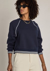 THE UPSIDE women’s navy organic cotton Astra Paloma Crew offers an oversized fit and features an embroidered horseshoe logo on front in navy. Made for lifestyle.