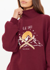THE UPSIDE women's maroon organic cotton Le Ski Clementine Crew is designed for an oversized fit and features Le Ski logo print & embroidery on front chest. Designed for Après-ski and winter wear.