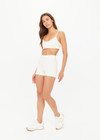 THE UPSIDE women's cream recycled peached Volant 3inch Spin Short is designed for a soft & supportive fit and features pockets and a ruffle frill at hem. Made for yoga & pilates.