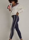 THE UPSIDE women's navy recycled peached Samara 25inch Legging is a soft & supportive fit and features side pockets and contrast cream stripes with curved hem detail. Made for pilates.