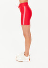 THE UPSIDE women's red eco tech Oxford 5-inch Spin Short is supportive and comfortable with mid-rise, cream side stripes, and elastic waist drawcord. Made for high impact.