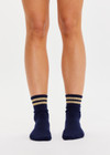 THE UPSIDE women’s navy Curio Crew Sock with jaquard stripes in gold metallic yarn.