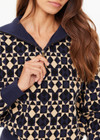 THE UPSIDE women's navy organic cotton Cosmo Kairo Half Zip Knit is a relaxed fit and features a half zip front and beige knitted stripes down sleeves. Made for everyday leisure.
