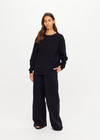 THE UPSIDE women's black recycled cotton Soho Cara Long Sleeve Top is designed for a relaxed fit and features a ribbed neck and cuffs and a patch pocket at front. Made for everyday leisure.