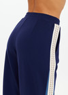 THE UPSIDE women's navy Lenzing viscose Petra Flare is designed for a true-to-size fit and features flare pants with splits and contrast chevron tape down side seams. Made for lifestyle.