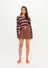 THE UPSIDE women's leopard organic cotton Malawi Karly Knit Mini Skirt offers a relaxed fit, featuring an elasticated waistband with orange drawcord and knitted stripes down sides. Made for lifestyle.