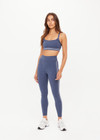 THE UPSIDE women's blue Bowery Baxter Tbar Sports Bra features a scooped neckline with ultraflex recycled fabrication, removeable bust cups and cream embroidered stripes at underbust. Made for yoga & pilates.