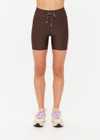 THE UPSIDE women's brown eco tech Oxford 5Inch Spin Short offers a mid rise with lilac coloured binds down side seams and an elastic drawcord through waist. Made for high impact.