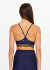 THE UPSIDE women’s navy recycled Eco Tech Salvador Zoe Sports Bra is breathable and features a scooped low neckline, T-bar back and adjustable straps. Made for yoga and pilates.