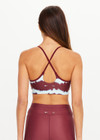 THE UPSIDE women’s tie dye recycled Rio Badu Crossback Sports Bra is a soft and supportive and features a scooped neckline, crossback straps and removable cups. Made for yoga and pilates.