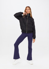 THE UPSIDE Peached Florence Flare in Navy is a sustainable high-rise full length flare pant with “V” waistband detail and printed arrow logo at back waistband.