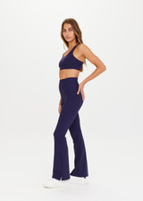 THE UPSIDE Peached Florence Flare in Navy is a sustainable high-rise full length flare pant with “V” waistband detail and printed arrow logo at back waistband.