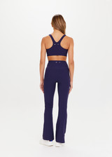 THE UPSIDE Peached Florence Flare in Navy is a sustainable high-rise full length flare pant with “V” waistband detail and printed arrow logo at back waistband.
